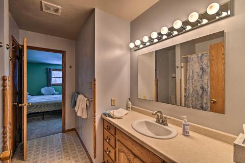 a bathroom with a sink and a mirror at Waterfront Fond du Lac Home on DeNeveu Lake! in Fond du Lac