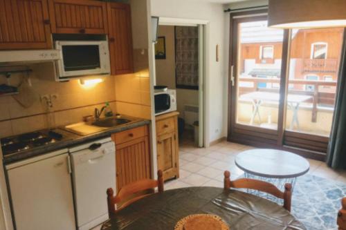a kitchen with a table and a dining room at Family Flat Cosy 35m Terrace 10m For 6 Pers in La Salle-les-Alpes