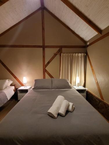 a bedroom with a bed with two towels on it at Hotel El Tesoro de Elqui in Pisco Elqui