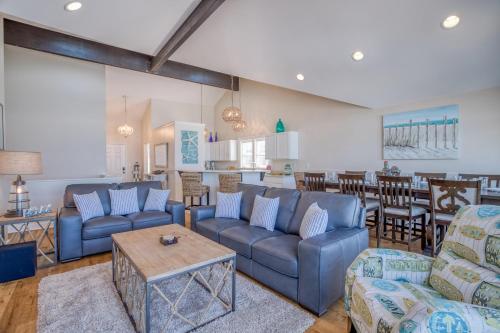 a living room with blue couches and a table at Beauty On The Beach in Depoe Bay