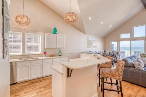 a kitchen and living room with a couch and a table at Beauty On The Beach in Depoe Bay