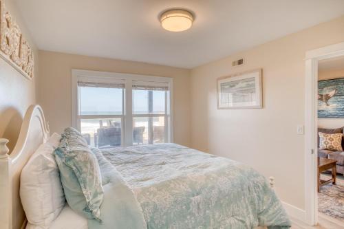 a bedroom with a bed and a window at Beauty On The Beach in Depoe Bay
