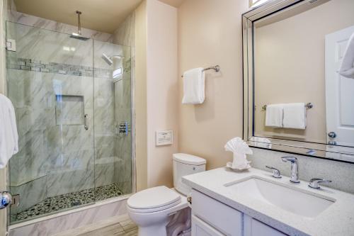 a bathroom with a shower and a toilet and a sink at Beauty On The Beach in Depoe Bay