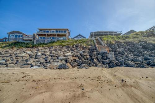 a pile of rocks on top of a beach at Beauty On The Beach in Depoe Bay