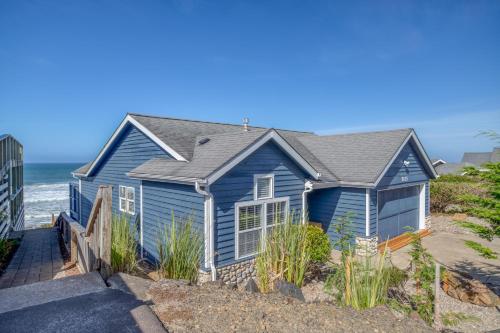 a blue house on the beach at Beauty On The Beach in Depoe Bay