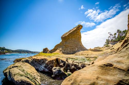 a rock formation on the shore of a body of water at Beauty On The Beach in Depoe Bay