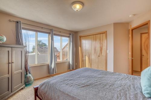 a bedroom with a bed and a large window at Hubbert Hideaway in Lincoln City