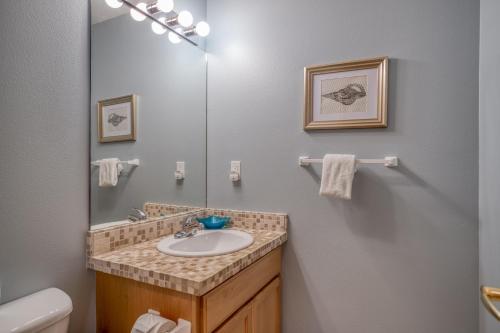 a bathroom with a sink and a mirror at Hubbert Hideaway in Lincoln City