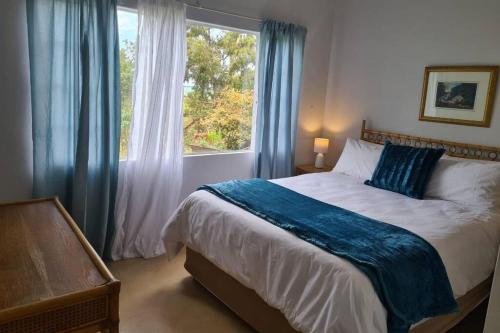 a bedroom with a large bed and a window at Hilltop Farm Valley View Cottage in Rosetta