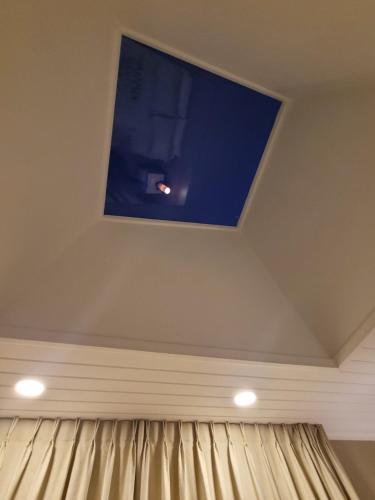 a room with a flat screen tv on the ceiling at Hotel El Tesoro de Elqui in Pisco Elqui