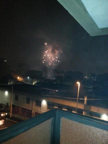 a firework display in the sky over a city at night at B&B United States of Europe in Catania