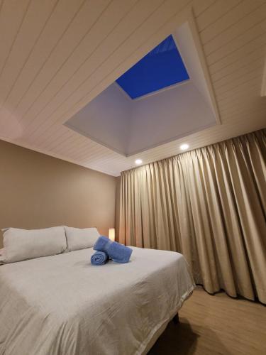 a bedroom with a bed with a blue towel on it at Hotel El Tesoro de Elqui in Pisco Elqui