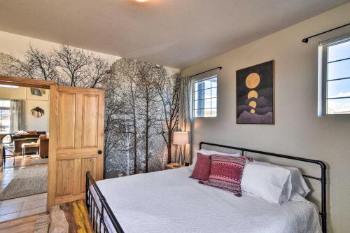 a bedroom with a bed and a large window at 503 Mountain Loft with Views 1 Mi to Dwtn Fairplay! in Fairplay