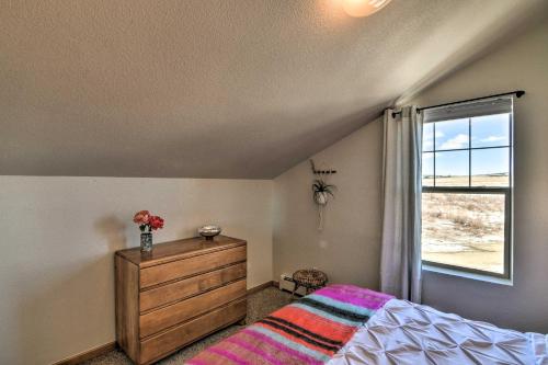a bedroom with a bed with a dresser and a window at 503 Mountain Loft with Views 1 Mi to Dwtn Fairplay! in Fairplay
