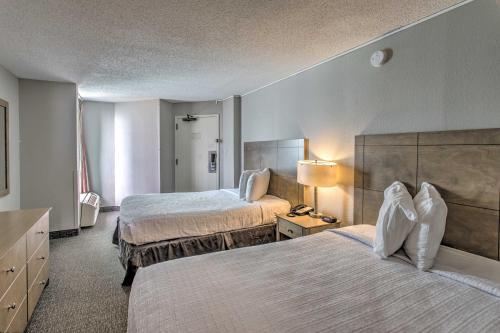 A bed or beds in a room at Breezy Landmark Resort Condo with Oceanfront Lanai!