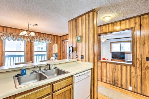 a kitchen with wooden cabinets and a sink and a window at Beech Mtn Condo w/ Slope View & Resort-Style Perks in Beech Mountain