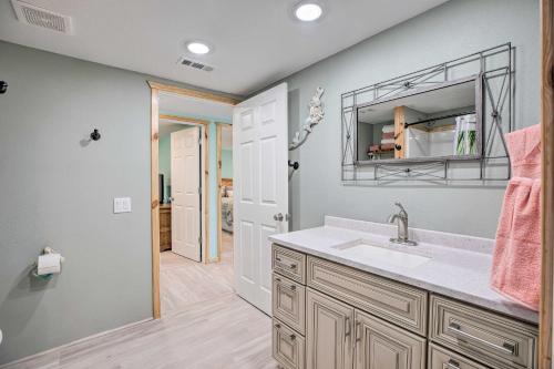 a bathroom with a sink and a mirror at Outdoor Family Fun Large Home by Beaver Lake! in Eureka Springs