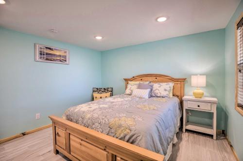a bedroom with blue walls and a bed and a nightstand at Outdoor Family Fun Large Home by Beaver Lake! in Eureka Springs