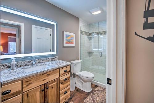 a bathroom with a toilet and a sink and a shower at Spacious Village of Loon Home Less Than 1 Mi to Ski Slopes in Lincoln