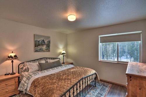 a bedroom with a bed and a window at 16-Acre Modern Fairplay Cabin with Mountain Views! in Fairplay