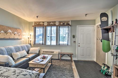 a living room with a couch and a table at Ski-InandSki-Out Getaway at Boyne Mountain Resort in Boyne Falls
