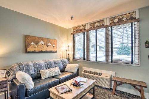a living room with a couch and a table at Ski-InandSki-Out Getaway at Boyne Mountain Resort in Boyne Falls