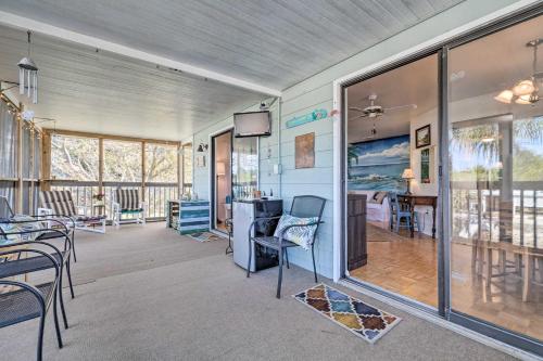 a living room with a table and chairs at Serene Hudson Home on Canal with Direct Gulf Access in Hudson