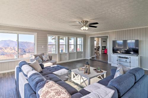 a living room with a blue couch and a tv at Near Hiking Trails Luxe Canton Getaway with Grill in Canton