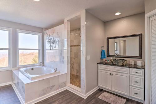 a bathroom with a tub and a sink and a mirror at Near Hiking Trails Luxe Canton Getaway with Grill in Canton