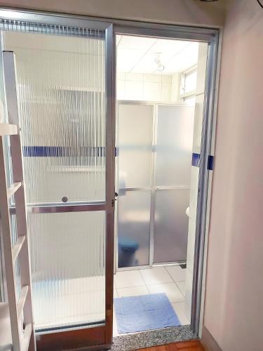 a glass door to a shower in a bathroom at Solar Hostel Beach Copacabana in Rio de Janeiro