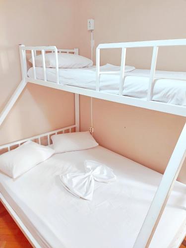 two bunk beds in a dorm room with a bow at Solar Hostel Beach Copacabana in Rio de Janeiro