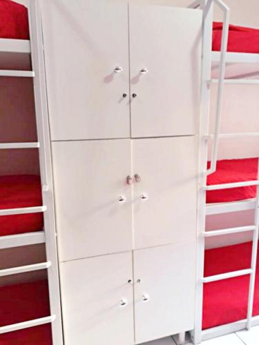 a white dresser in a bedroom with a bunk bed at Solar Hostel Beach Copacabana in Rio de Janeiro