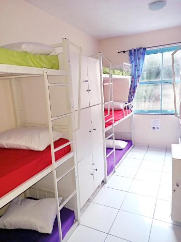 a dorm room with bunk beds and a window at Solar Hostel Beach Copacabana in Rio de Janeiro