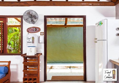 a kitchen with a door open to a patio at Pousada Farol de Caraíva in Caraíva