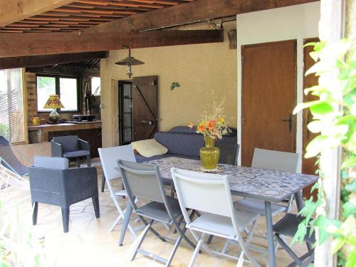 a patio with a table and chairs and a couch at LOUCABANON VAR in Draguignan