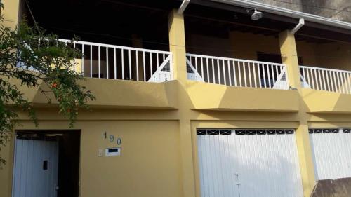 un balcón en el lateral de una casa en Santa Helena Pousada, en Cachoeira Paulista