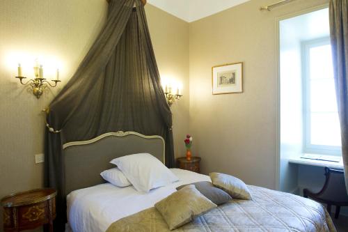 a bedroom with a bed with a canopy at Château De Pray in Amboise