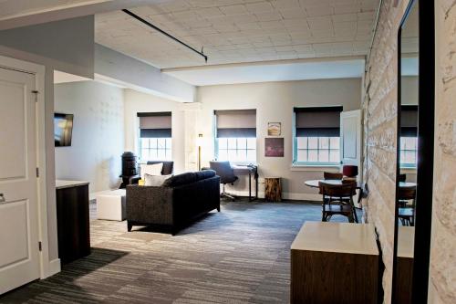 a living room with a couch and a table at Hotel Millwright in Amana