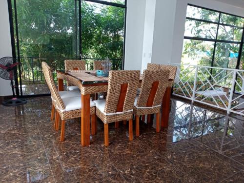 a dining room with a wooden table and chairs at CASA EL MIRADOR in Anapoima