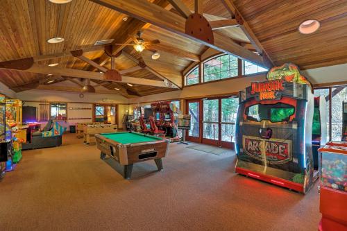 a room with a pool table and a arcade game at Ski-InandSki-Out Northstar Condo Near Lake Tahoe! in Truckee