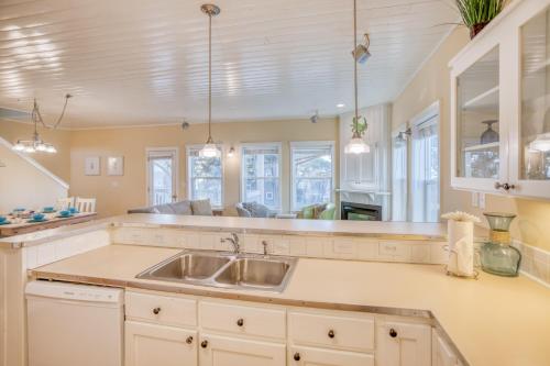 a kitchen with a sink and some windows at Sunset 389 in Depoe Bay