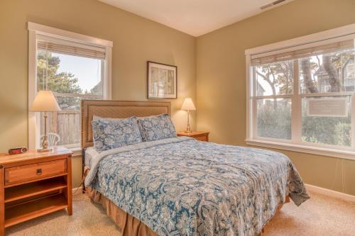 a bedroom with a bed and two windows at Sunset 389 in Depoe Bay