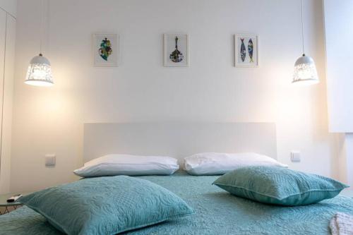 two pillows sitting on a bed in a bedroom at Casa 53 in Aveiro