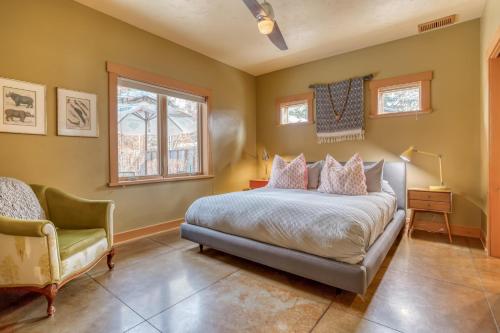 a bedroom with a bed and a chair at The Davenport - Meredith Lodging in Bend
