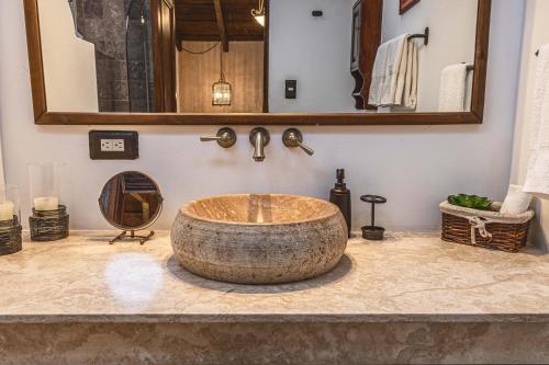 a bathroom with a large wooden sink on a counter at Villa 14 Santa Ines Antigua Guatemala in Antigua Guatemala