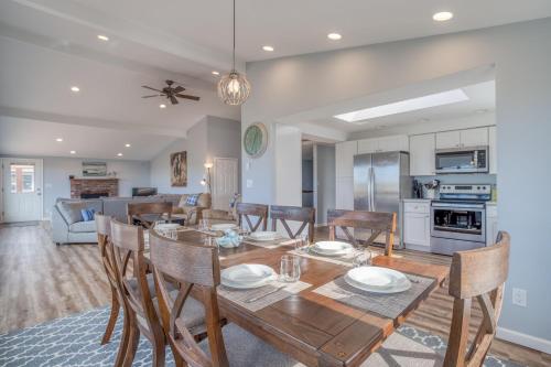 a dining room and living room with a table and chairs at Windsong Hideaway in Waldport