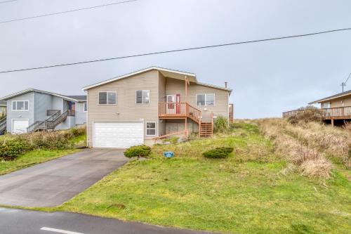 a house on the side of a hill with a driveway at Windsong Hideaway in Waldport