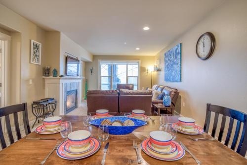 a dining room with a table with dishes on it at Herons View at Bridgeport - Meredith Lodging in Seaside