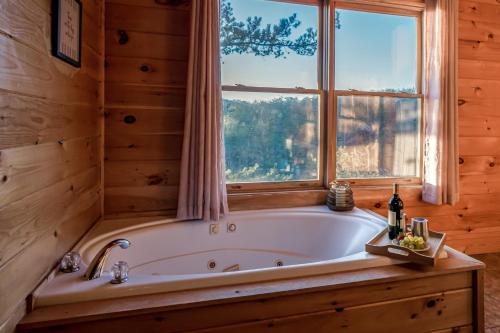 a bath tub in a room with a window at FALL SPECIAL! NERF Party, Pool, HotTub, Pet Friendly in Sevierville