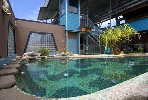 a large swimming pool in front of a building at Aspect Central in Cairns
